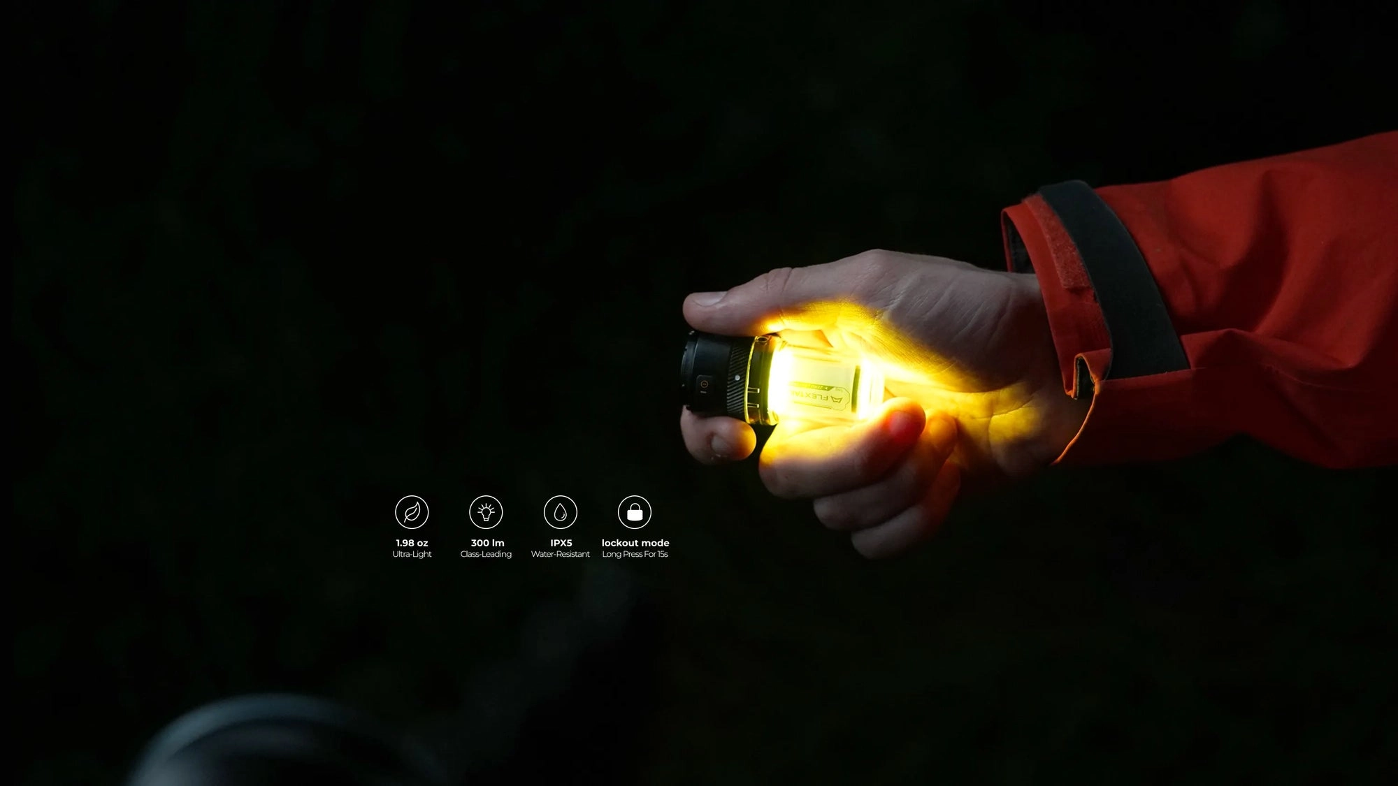 A glowing lantern held in a hand against a dark night
