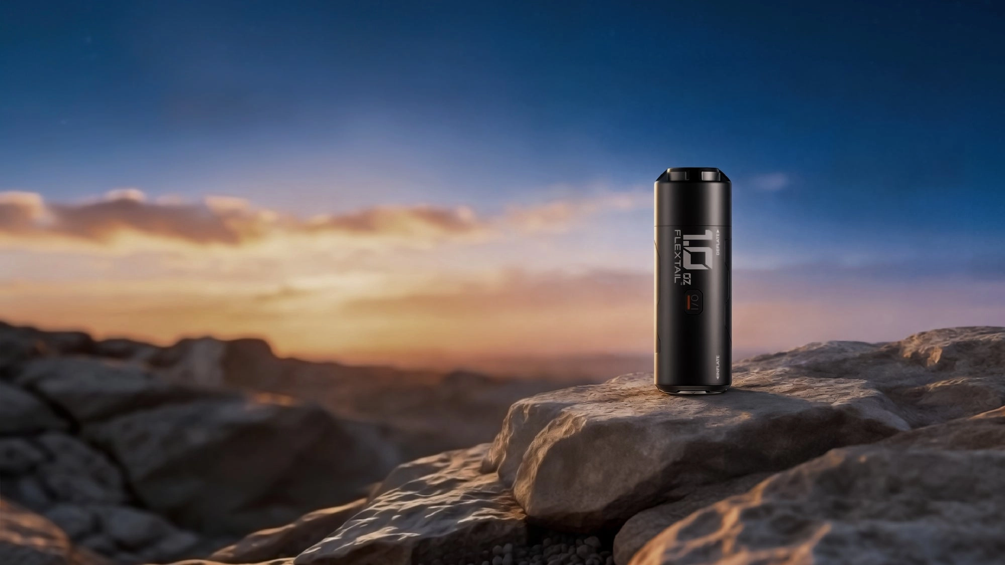 A FlexTail power bank resting on a rock at sunrise